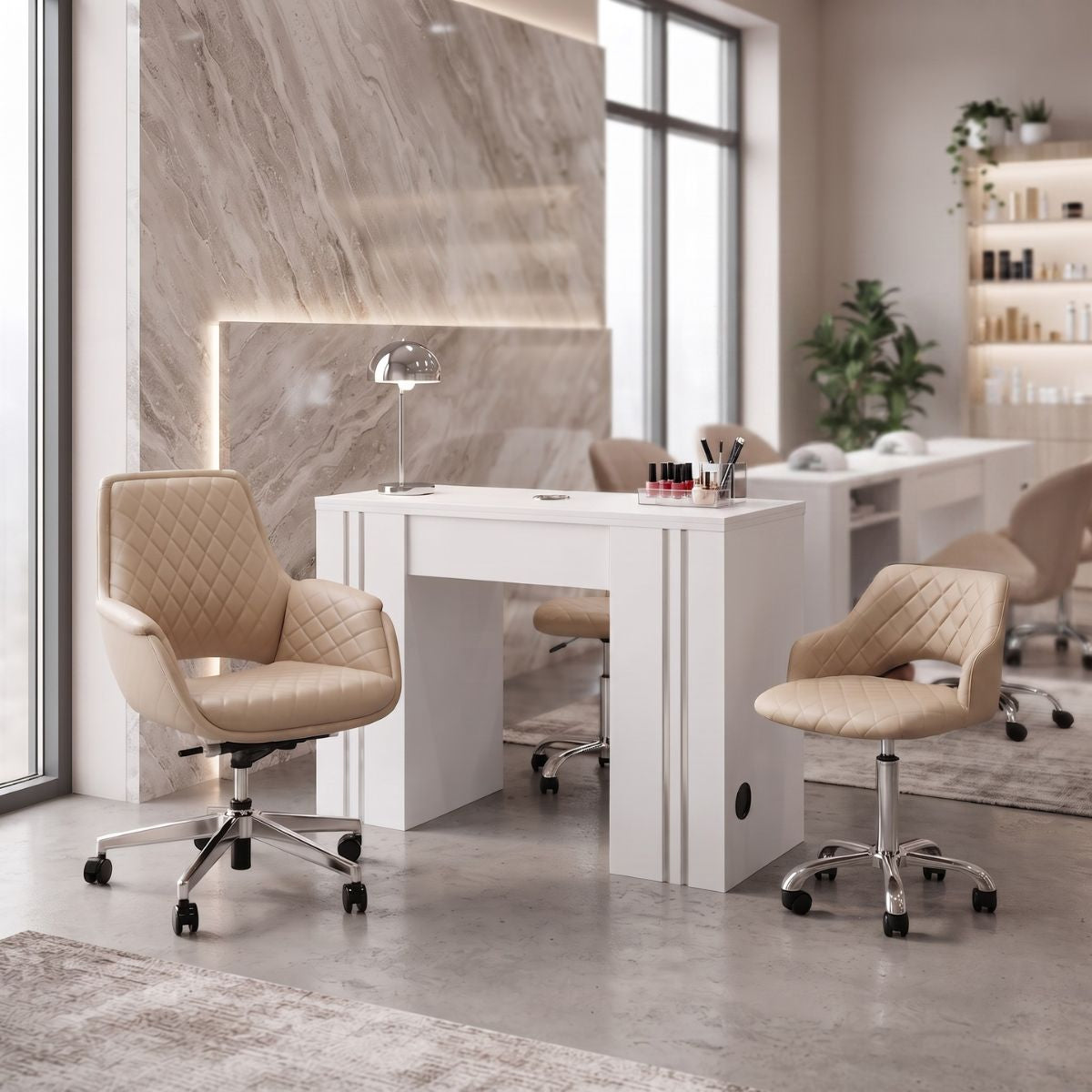 Modern white manicure table with beige quilted client and technician chairs in a luxury nail salon setup.