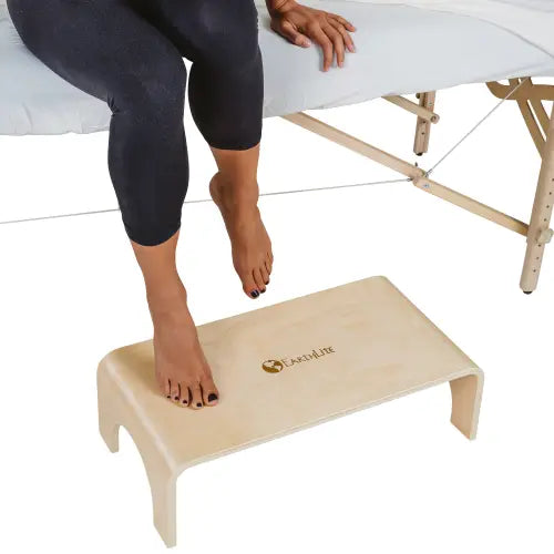 Heavy-duty non-slip step-up platform placed beside a stationary spa treatment table.