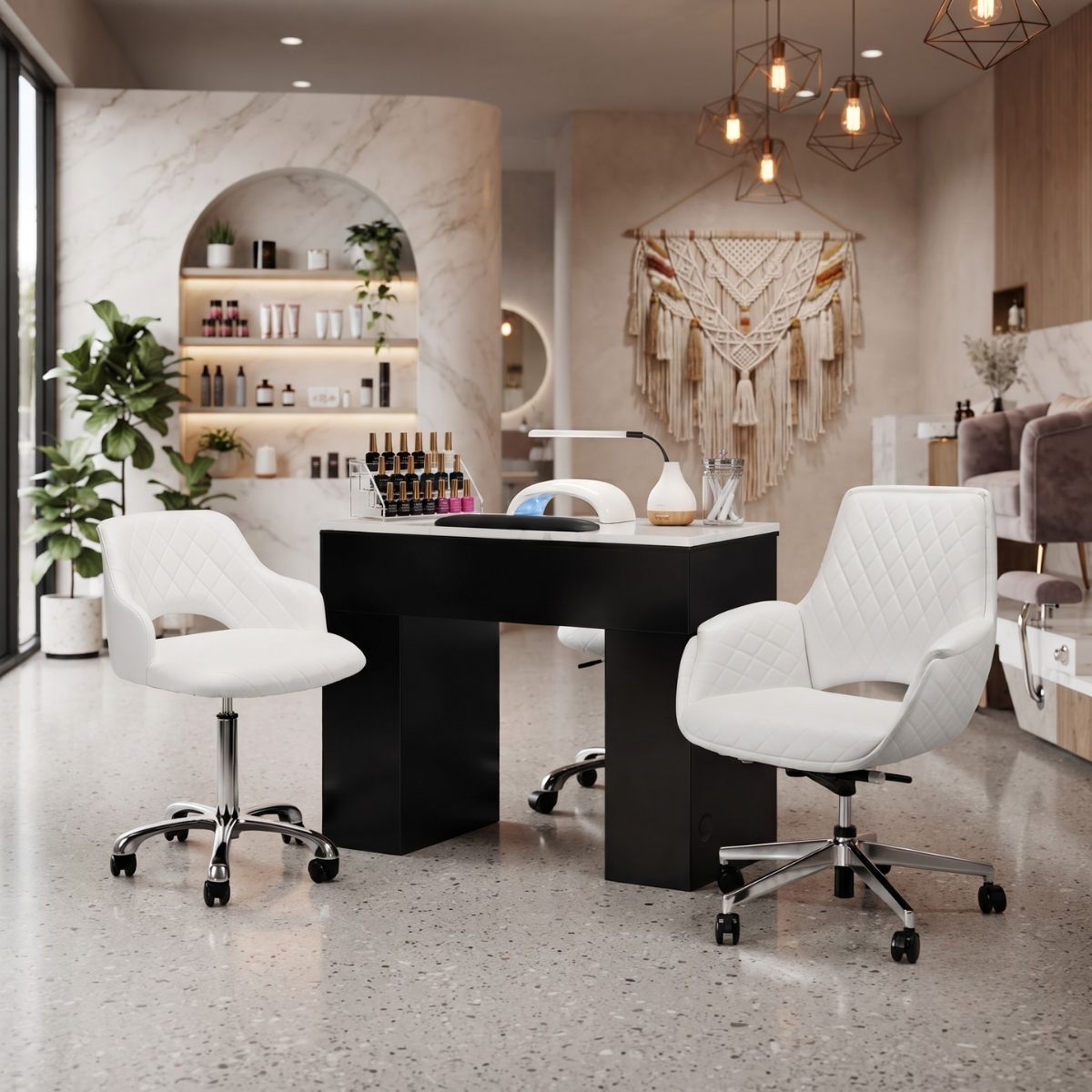 Modern nail salon interior featuring a black manicure table, white quilted rolling chairs, and boho decor.