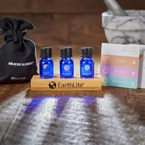 Glass bottles of aromatherapy essential oils and massage body oil on a spa treatment table.