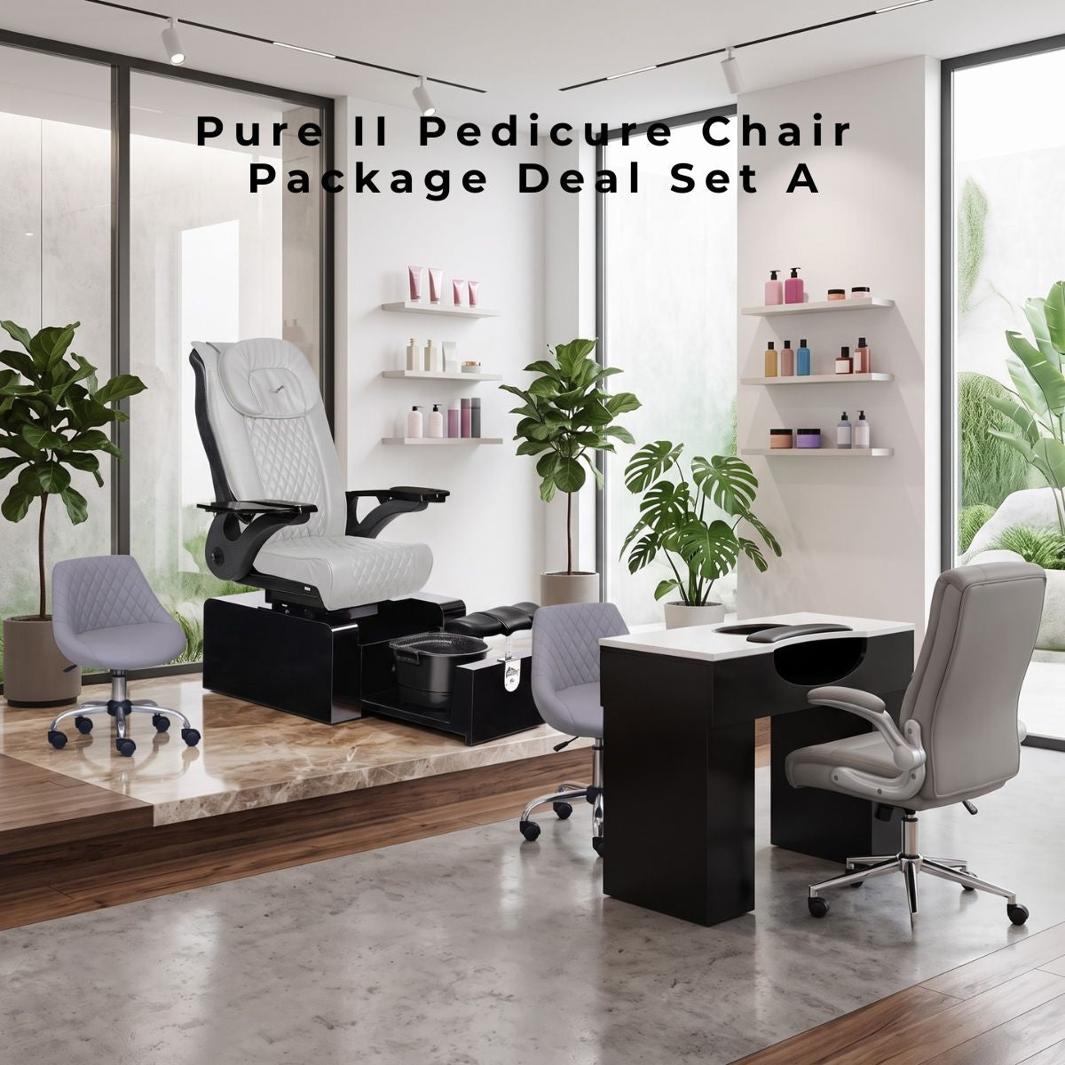 Product shot of the Pure II Pedicure Chair Package Deal Set A in a modern salon. Includes a white, diamond-quilted pedicure chair with a black base and basin; a matching black manicure desk with a white top; a grey technician stool; and a grey client chair. The set is displayed on a raised platform with marble inlay, surrounded by large windows, two potted Fiddle Leaf Fig trees, and floating shelves with products.
